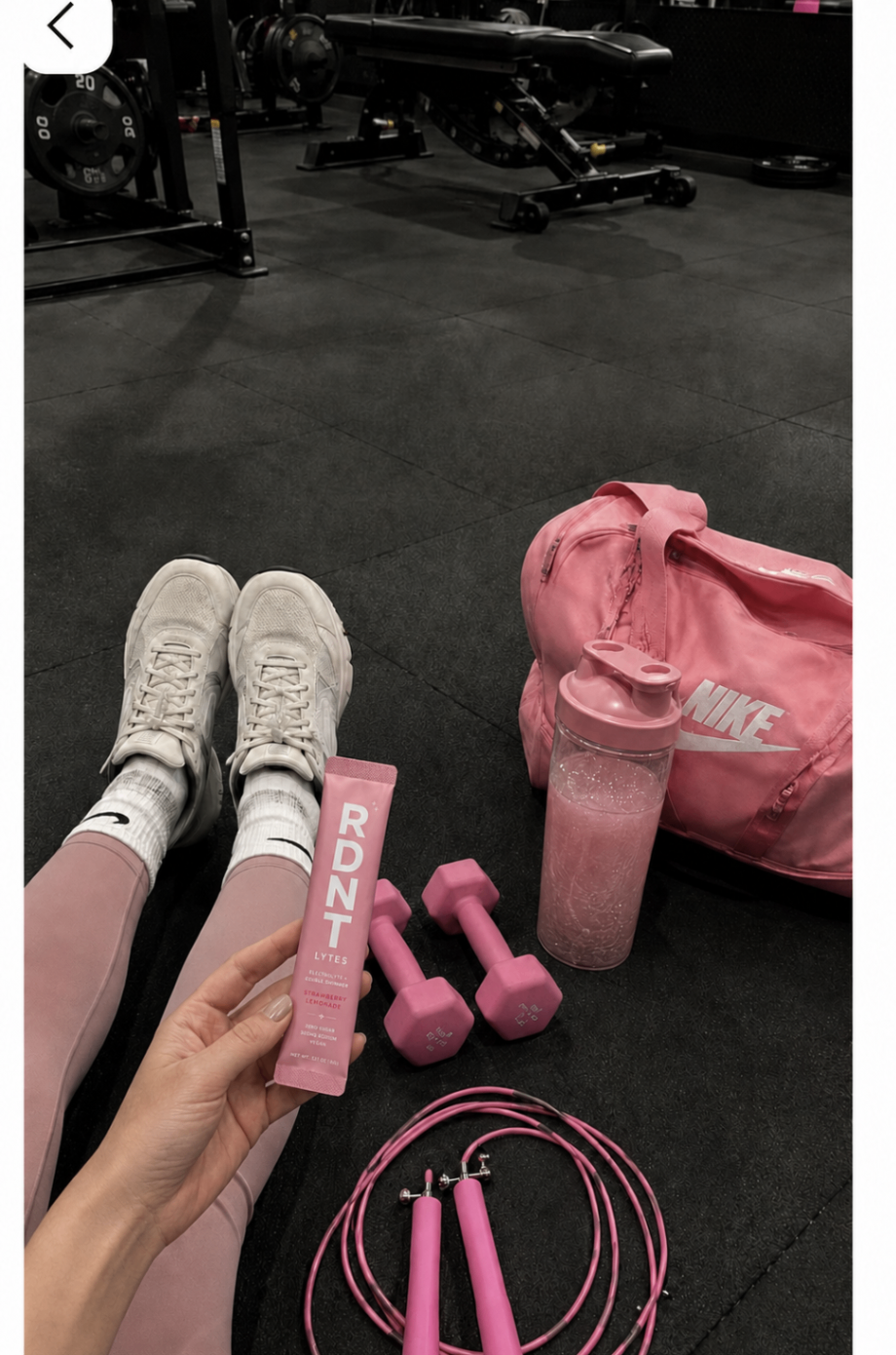 RDNT LYTES sachet with pink dumbbells in a bright home gym